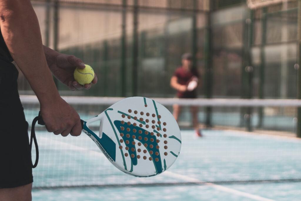 arm holding a padel racket