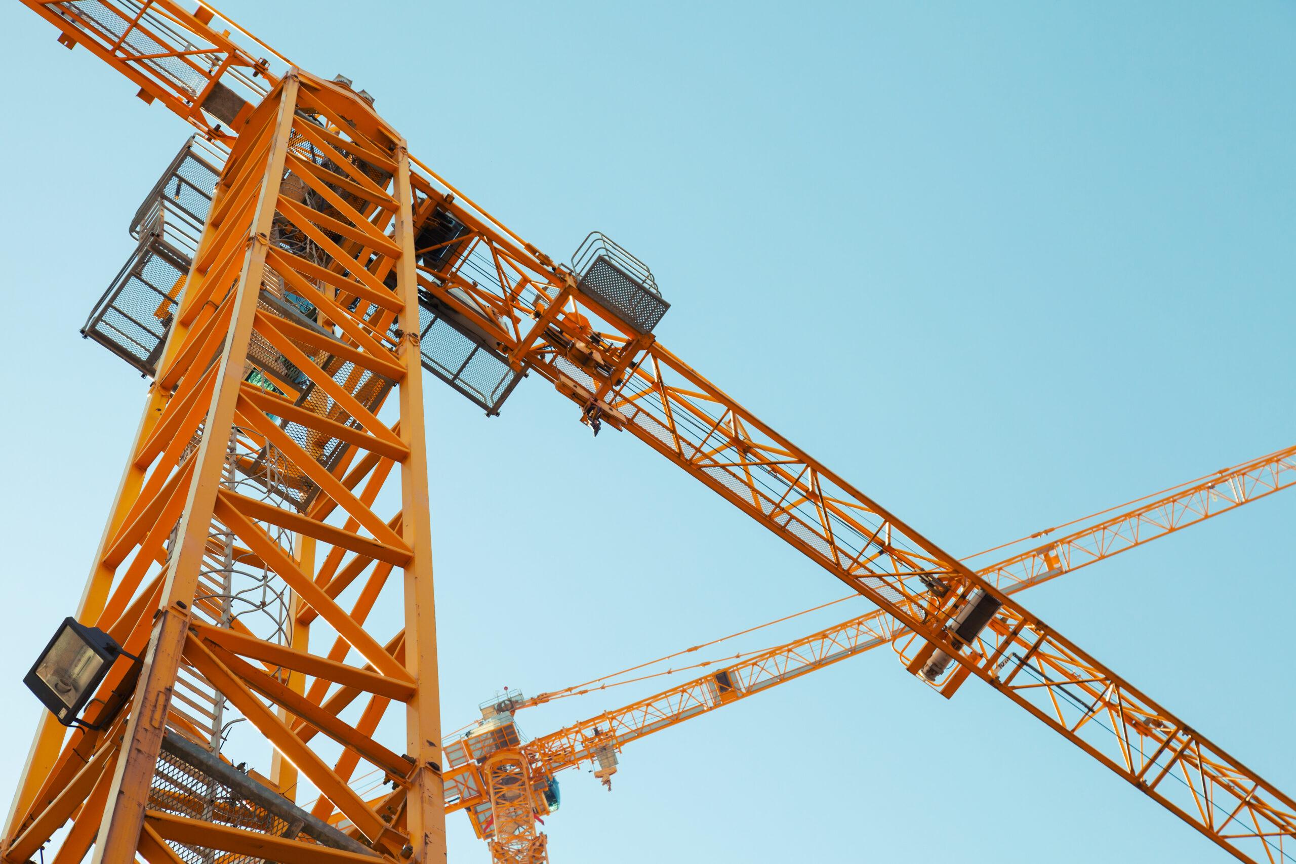 blue sky with yellow crane in foreground